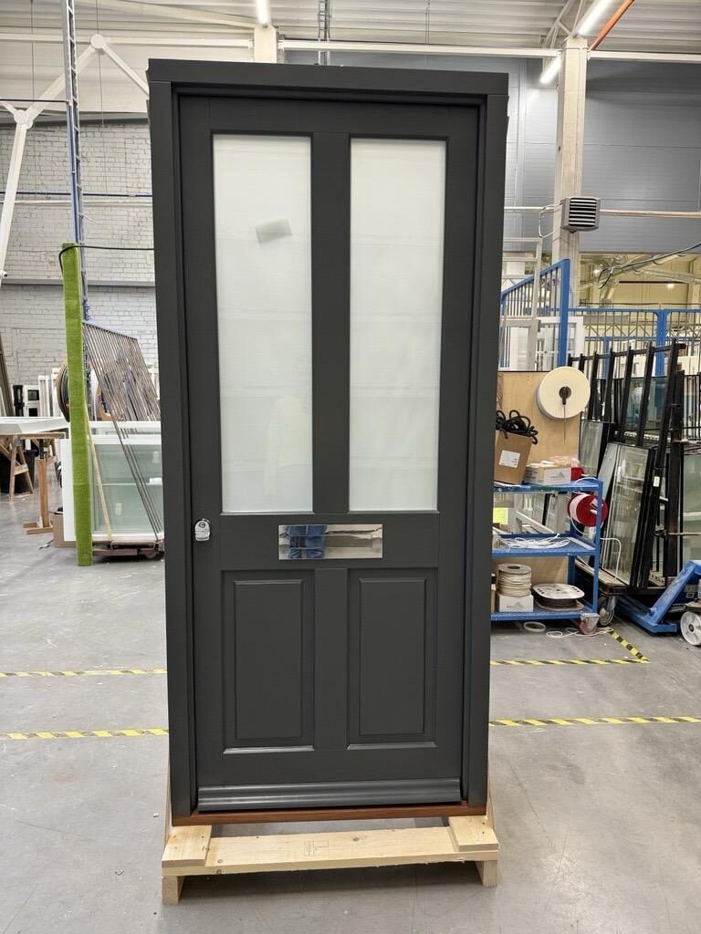 Anthracite grey timber front door with frosted glazing in our joinery workshop