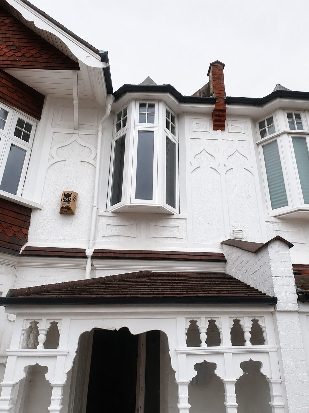 New timber casement windows on a period Arts and Crafts house with ornate porch