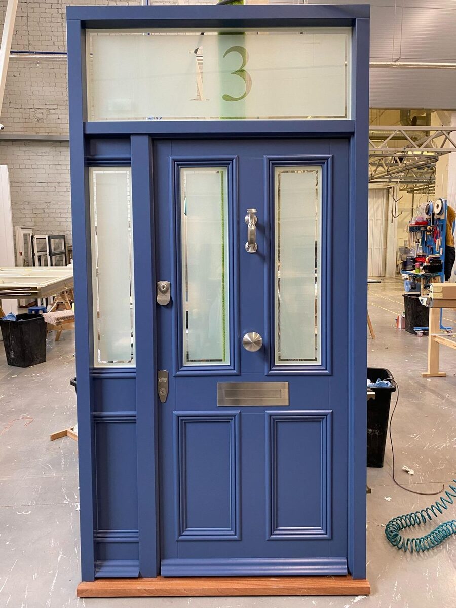 Blue Victorian timber door set with etched sidelights and numbered fanlight