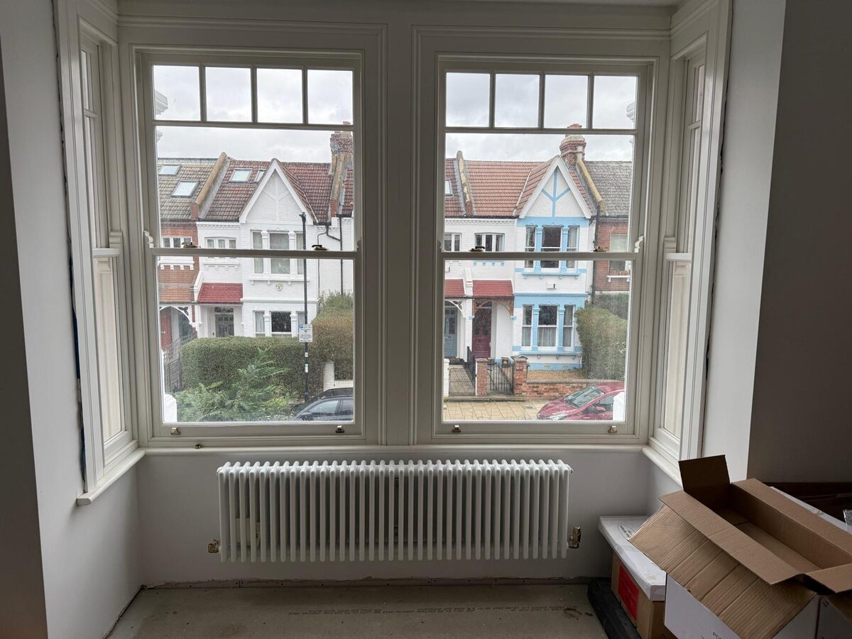 Newly fitted timber sash bay windows with toplights in an Edwardian living room
