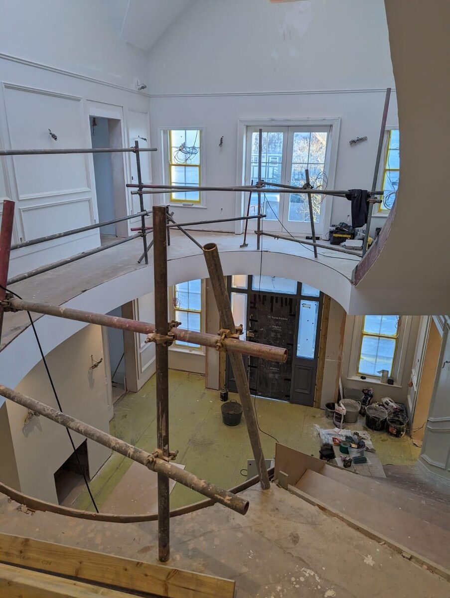 Galleried hallway renovation with timber windows and glazed entrance door