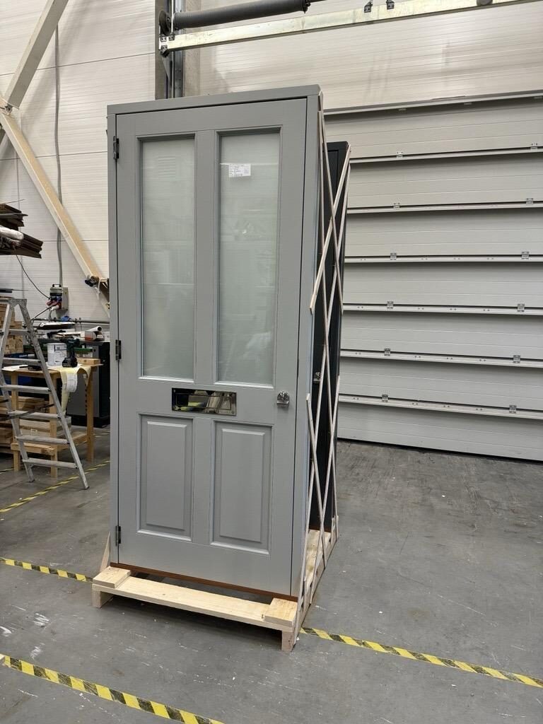 Light grey timber front door with frosted glazing crated in our joinery workshop