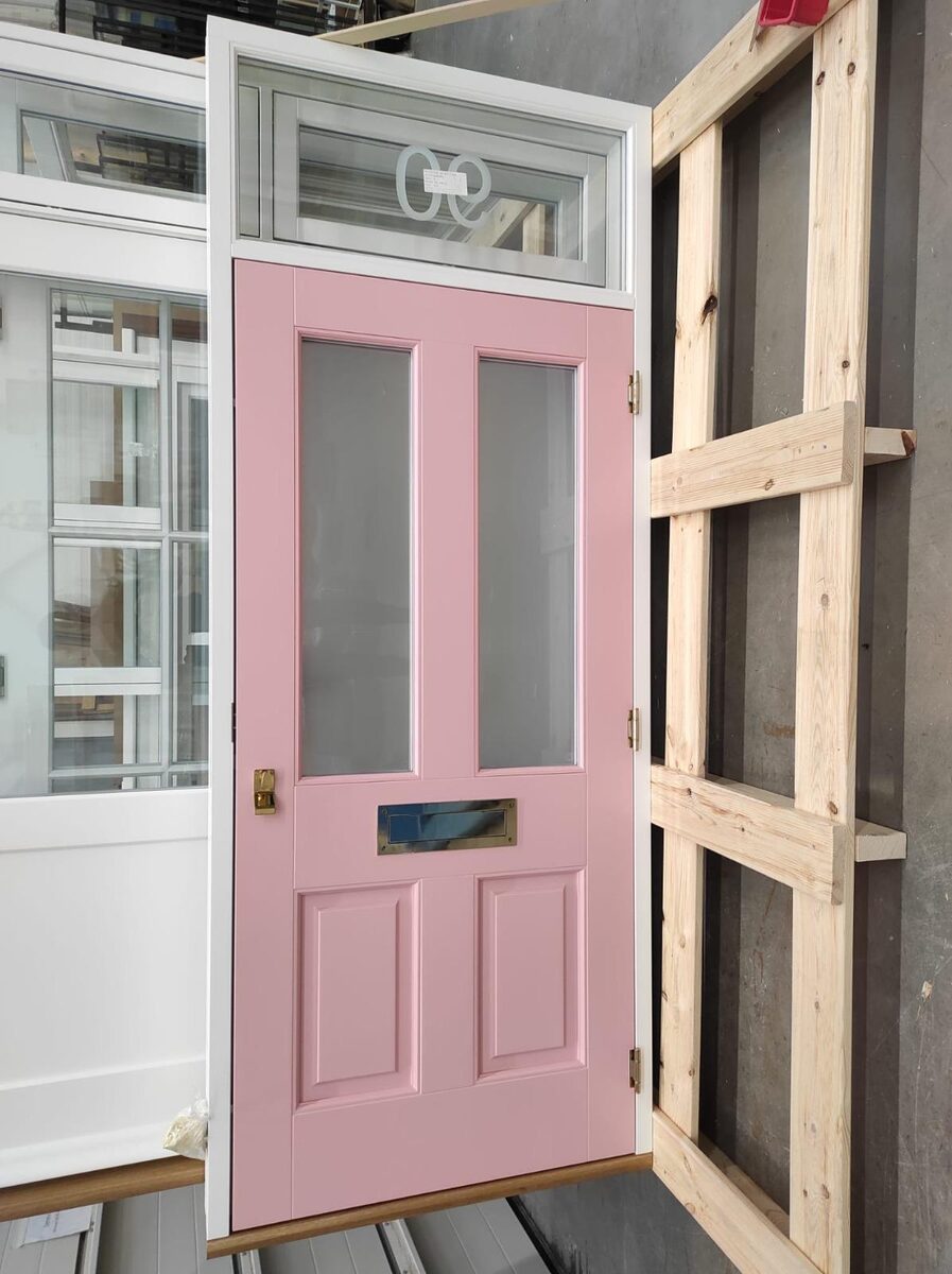 Pink Victorian timber front door with etched glass transom and brass letterplate