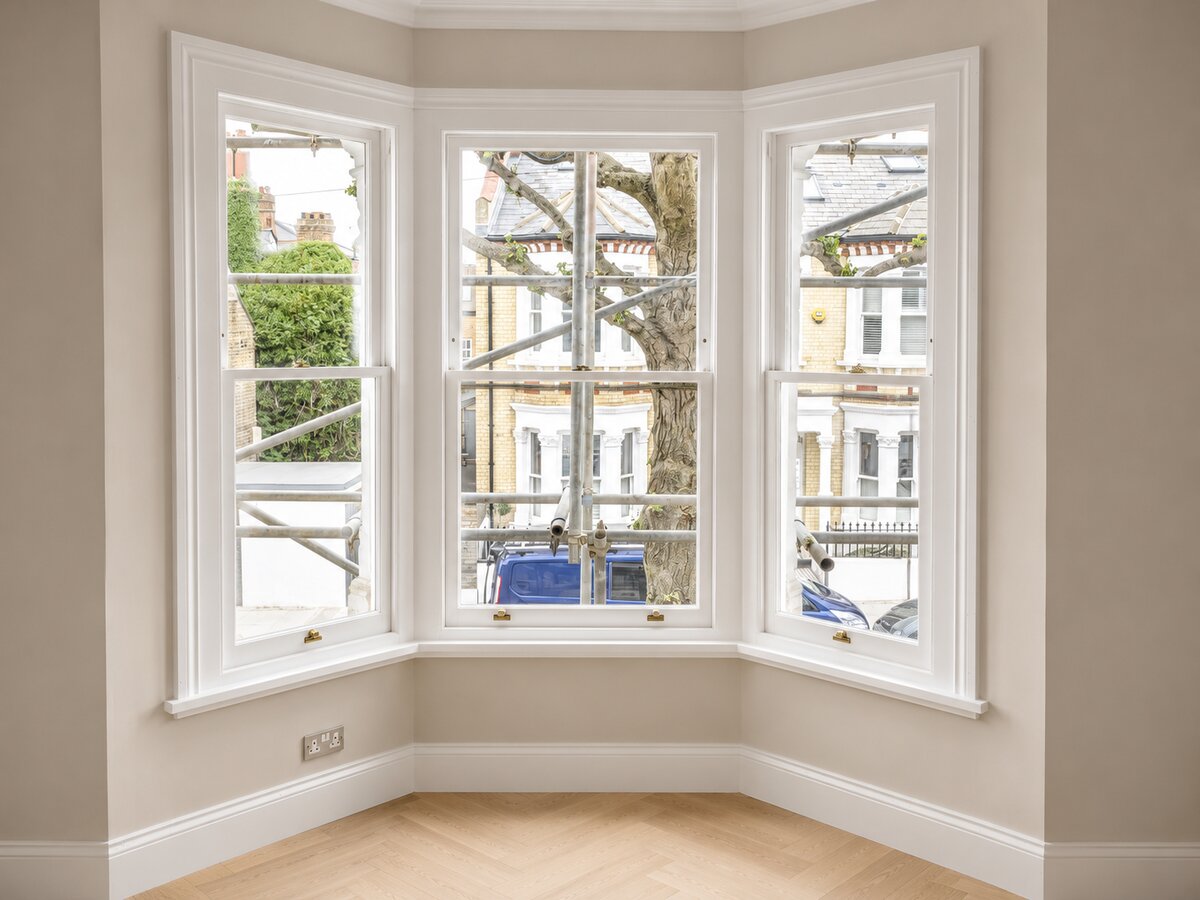 New white timber sash bay windows in a finished Victorian living room in South West London