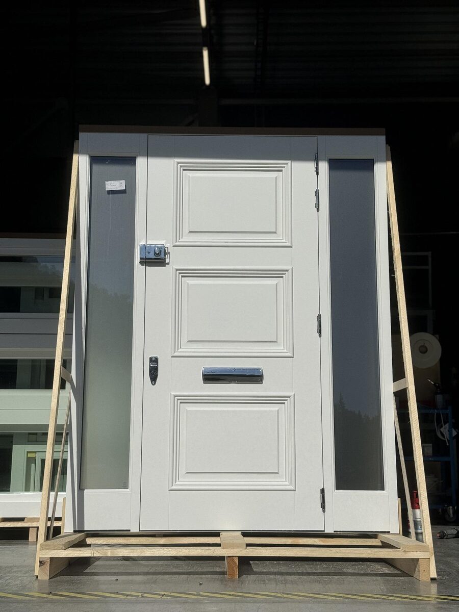White three-panel timber front door with frosted glass sidelights crated in the workshop